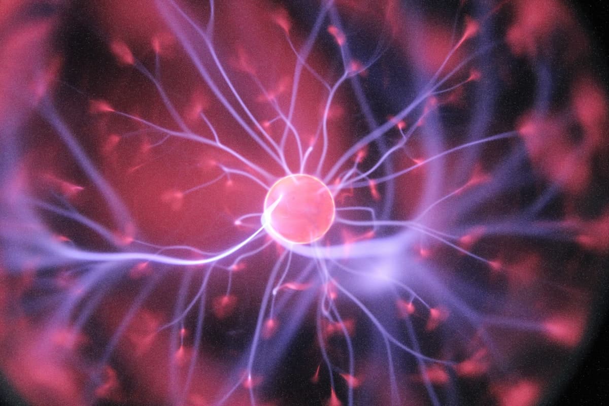 Abstract violet filaments of light radiating from a warm center